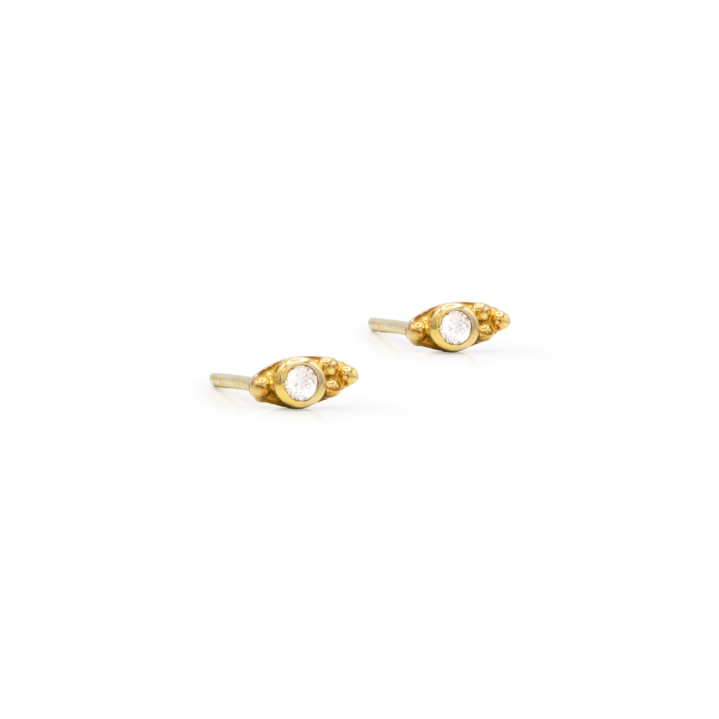 A pair of gold-plated sterling silver stud earrings with zircon stones.